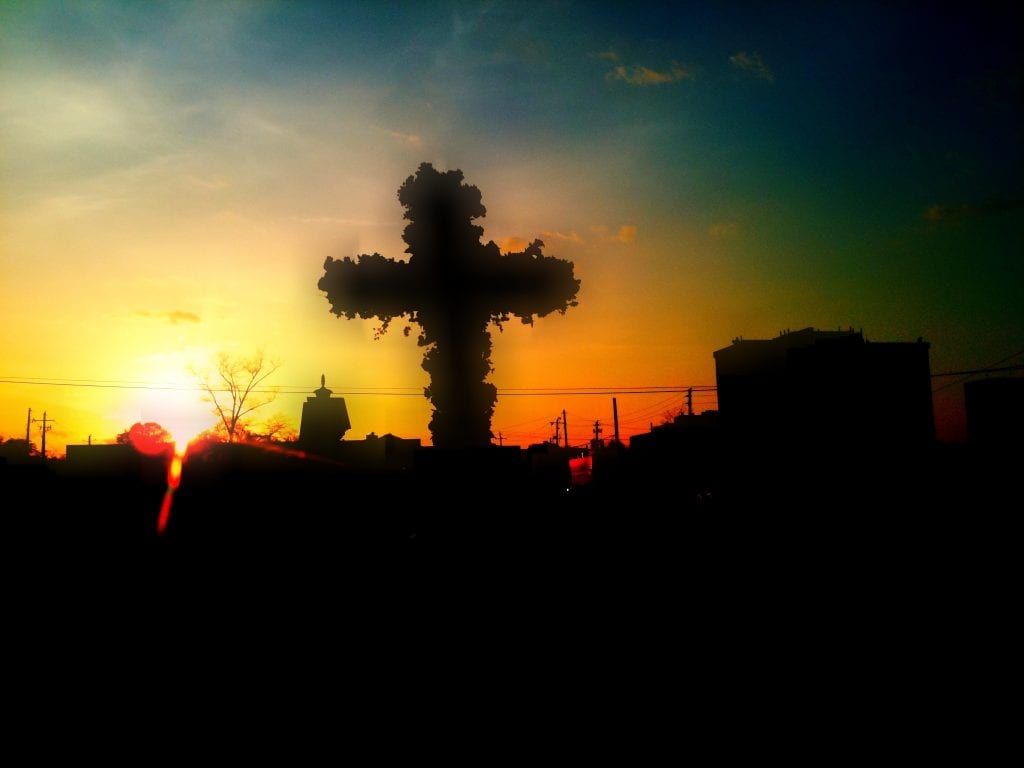 Sunrise in front of a cross during Easter